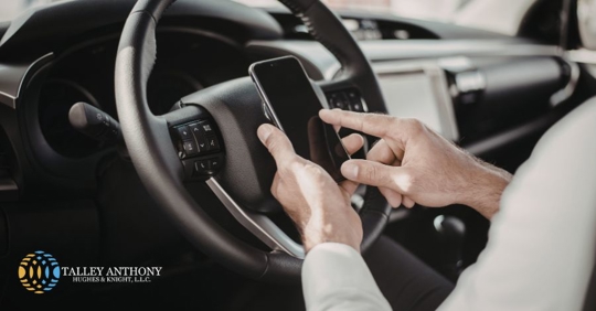 person using the phone while driving